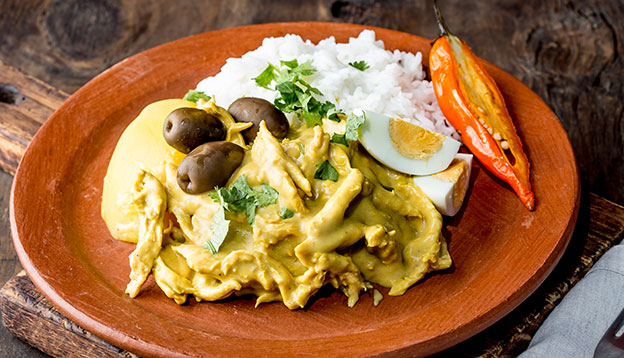 Close up of Aji de Gallina - Peruvian Yellow Spicy Creamy Chicken.