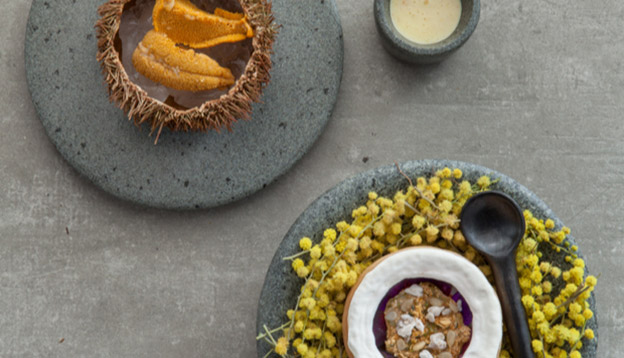 Close up of dishes from Borago set on a grey stone background