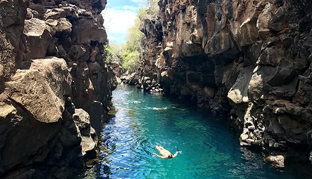 People swimming in a natural pool in Santa Cruz Island, Galapagos