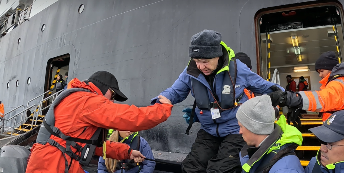 Chimu guest boards a zodiac in Antarctica. 