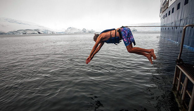 Passenger diving into the icy water - polar plunge