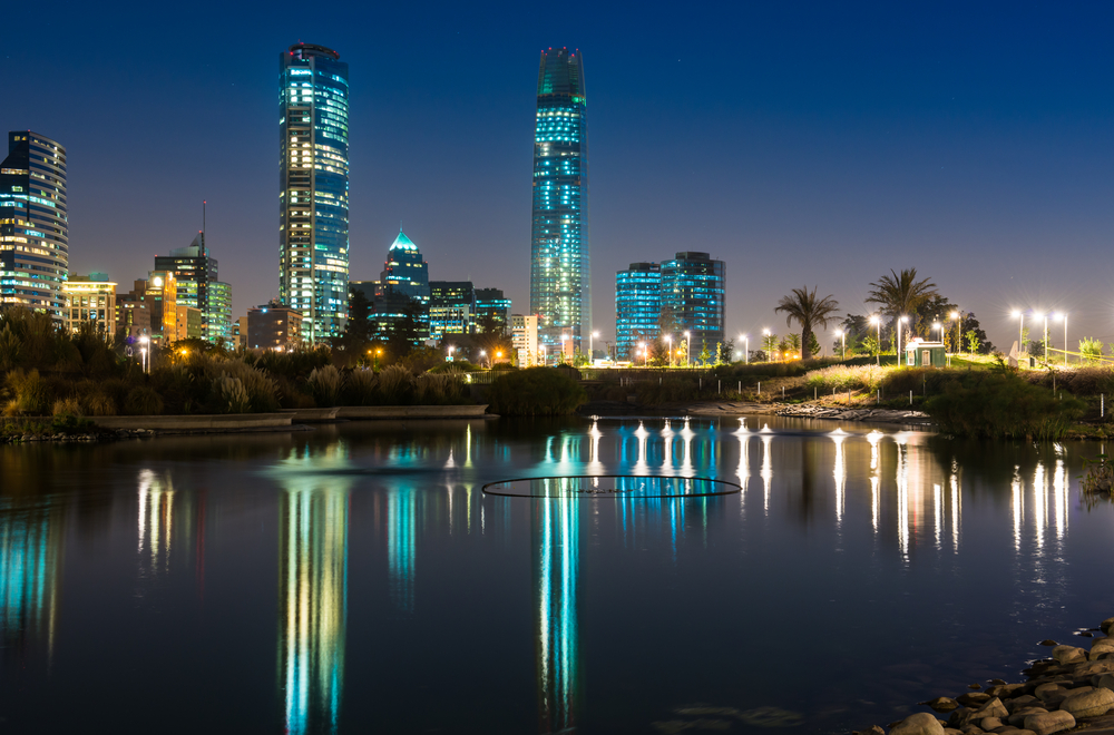 santiago in South America skyscrapers lights by night next to water