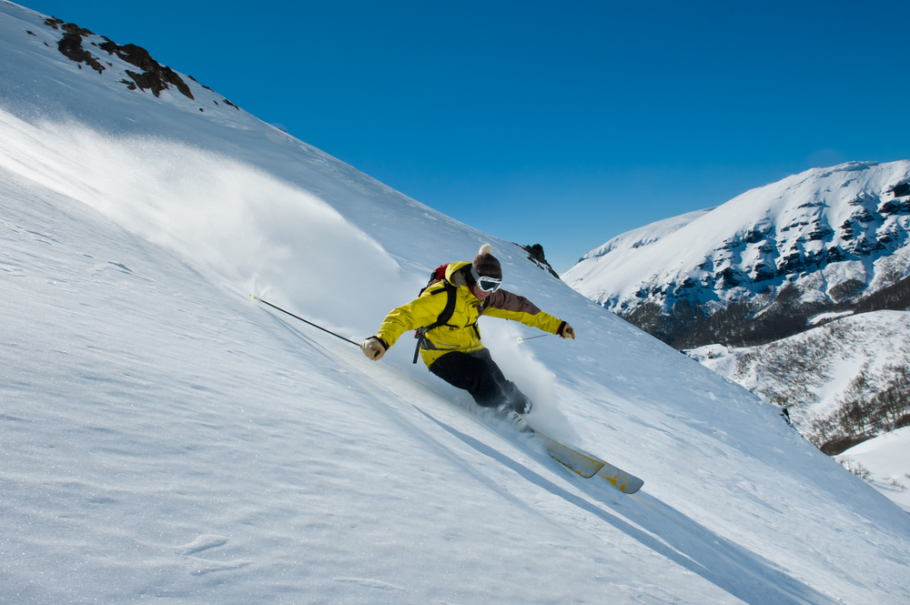 a guy skiing in the fresh snow in the mountains