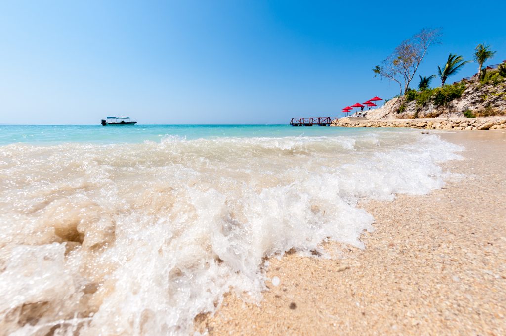 Caribbean beach with a boat in the background in Colombia