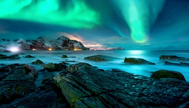 Aurora borealis above the snowy islands of Lofoten. 